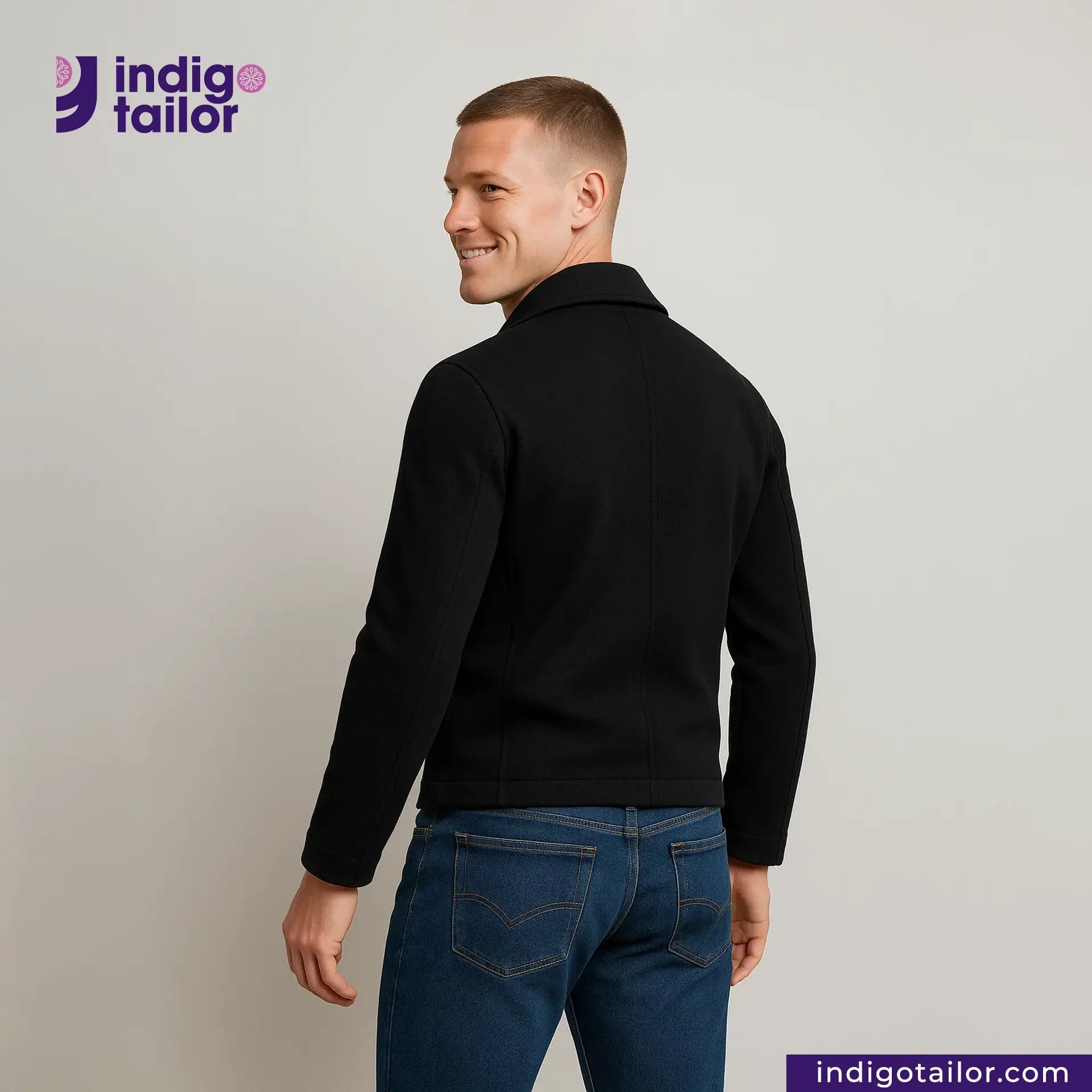 Man wearing a Double Breasted Knit Peacoat (Black) and blue jeans with 'Indigo Tailor' logo and website on a gray background
