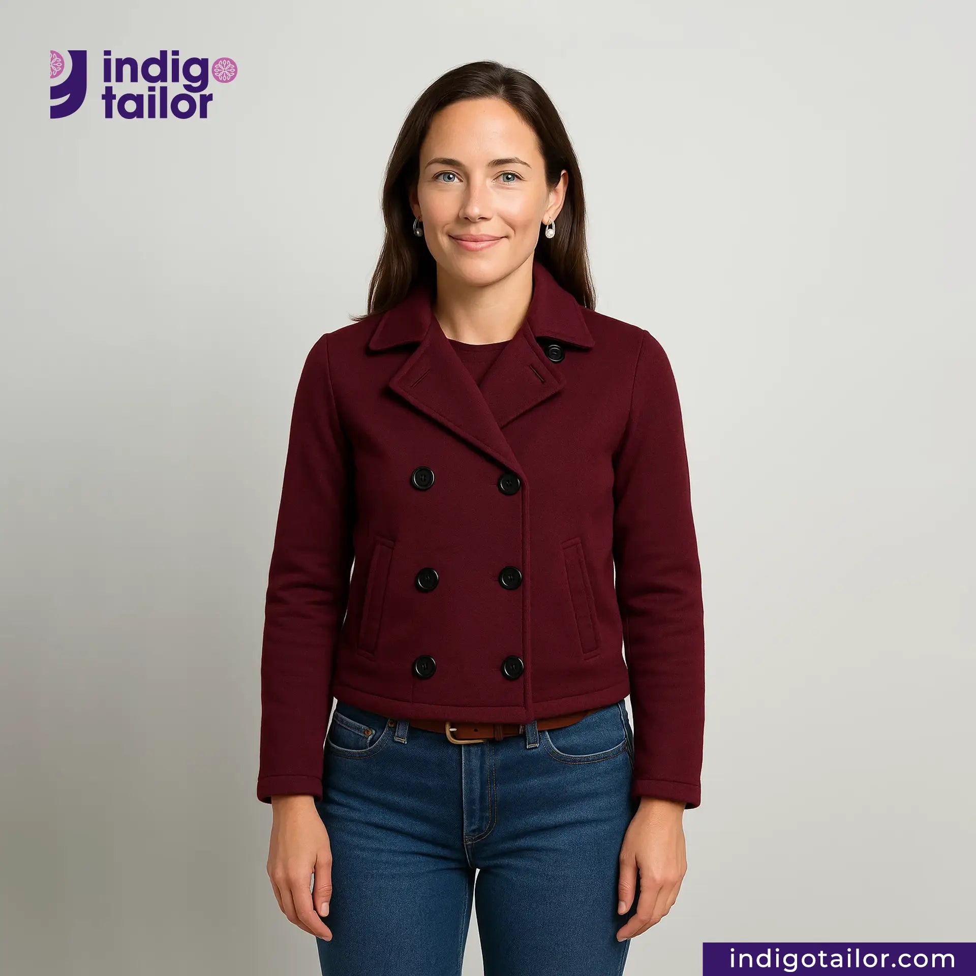 Woman wearing a Double Breasted Knit Peacoat (Burgundy) with 'Indigo Tailor' logo above her.