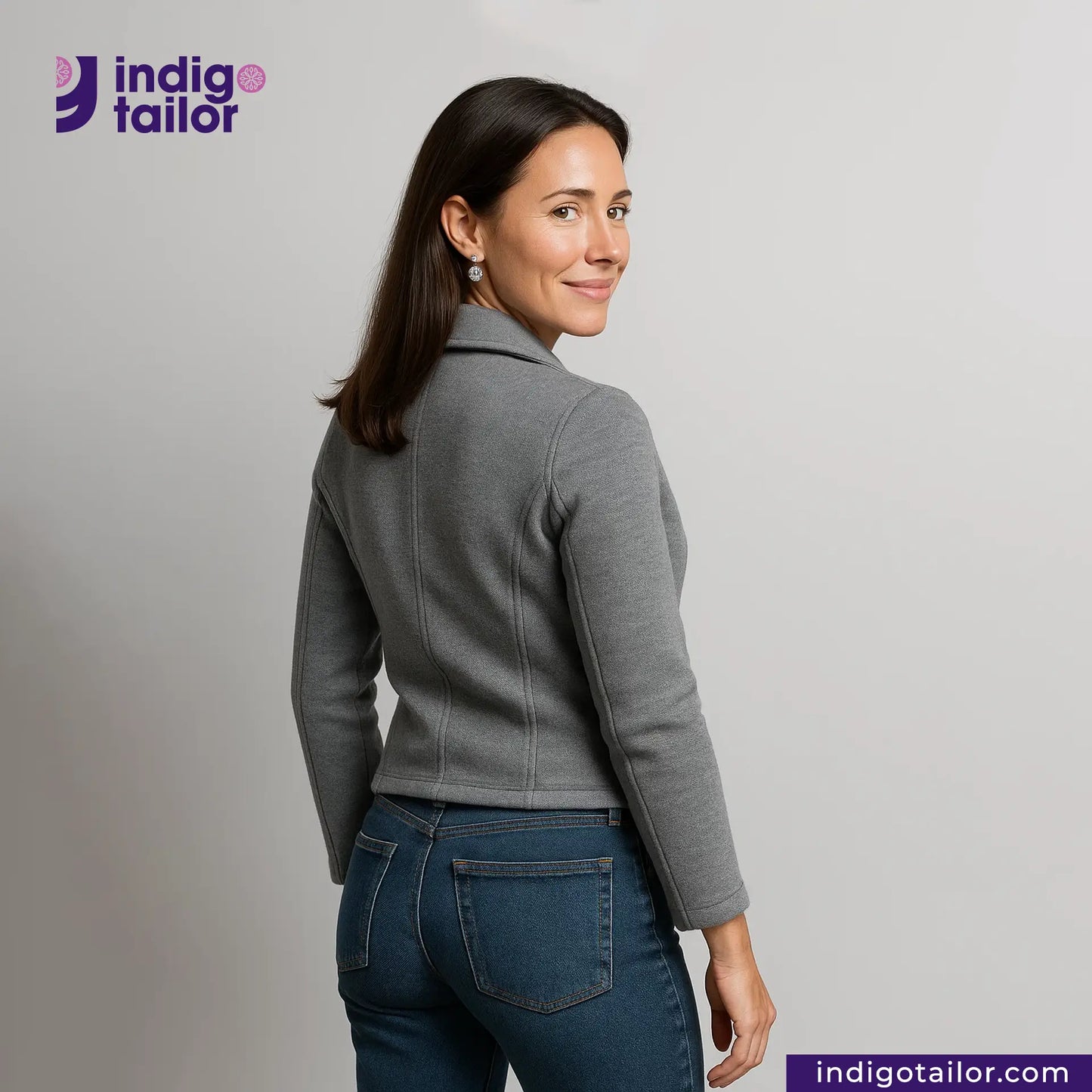 Woman wearing a Double Breasted Knit Peacoat (Grey) and blue jeans with 'Indigo Tailor' branding.