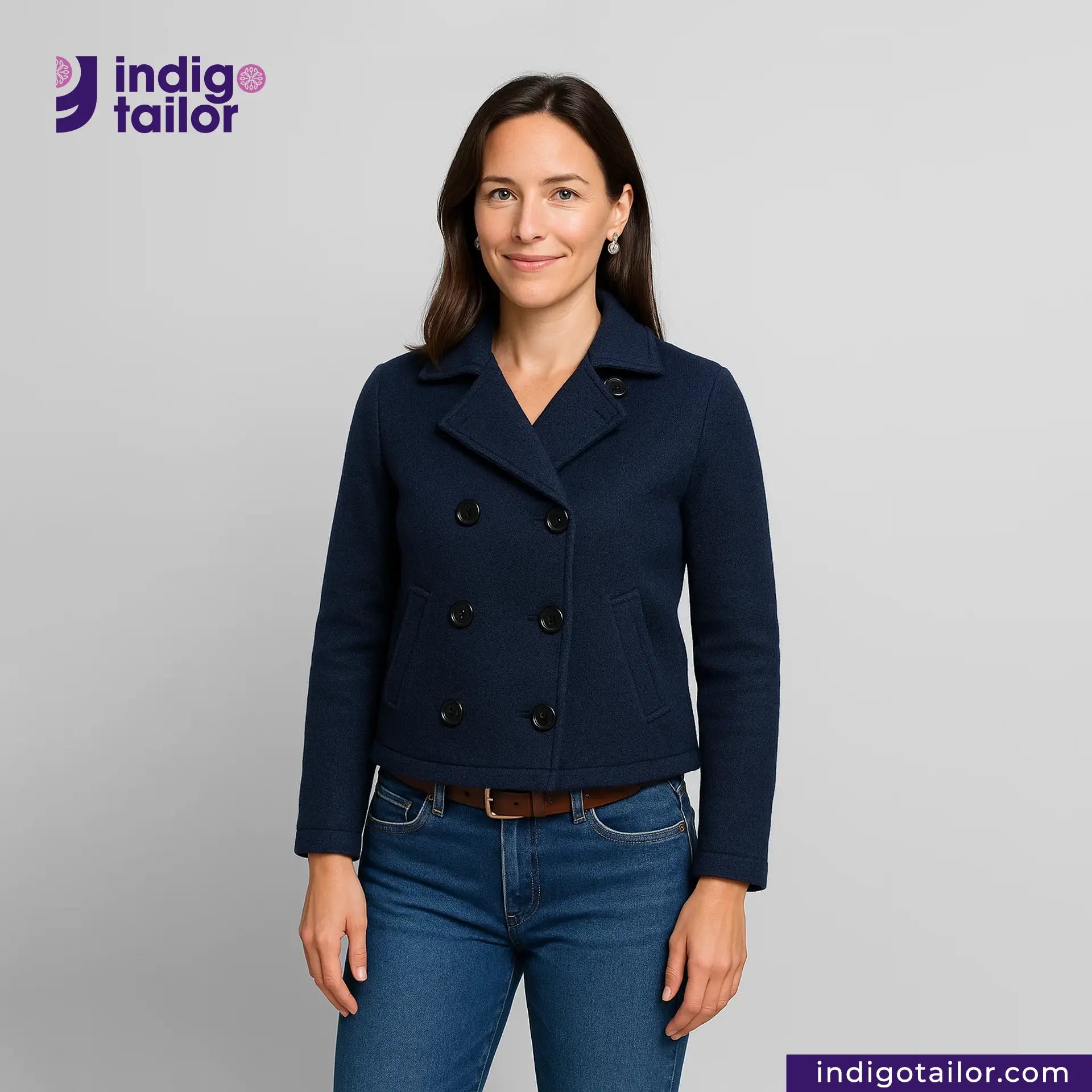 Woman wearing a Double Breasted Knit Peacoat (Navy) jacket with Indigotailor logo and website on gray background