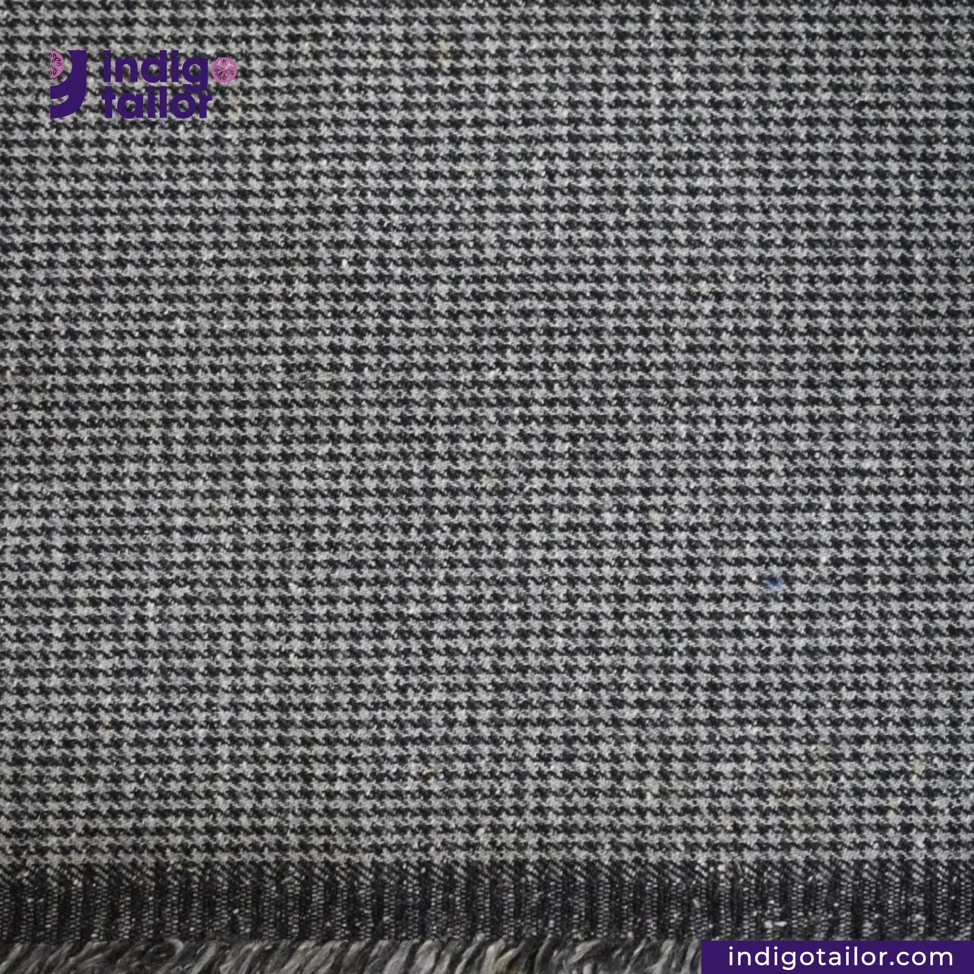 Close-up of GREYHOUND TWEED HOUNDSTOOTH fabric with 'Indigotailor' branding.