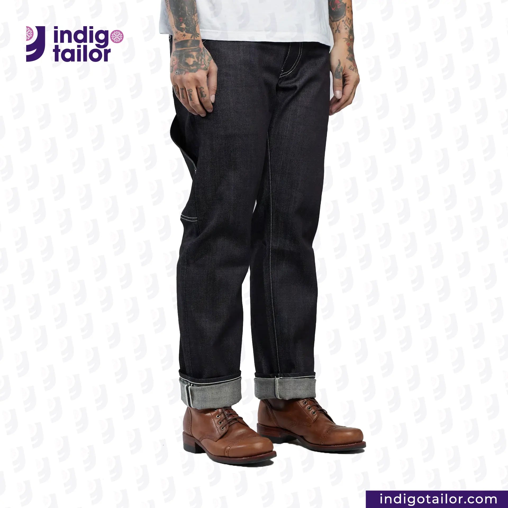 Person wearing INDIGO GREY DENIM jeans with rolled-up cuffs and brown shoes on a white background, featuring the Indigotailor logo.