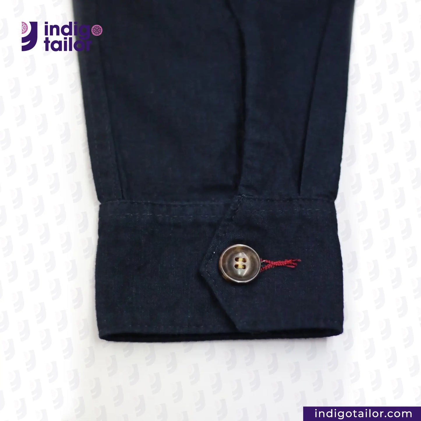 INDIGO HARRINGTON JACKET cuff with a button and embroidered design on a white background, featuring the Indigotailor logo.
