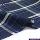 Close-up of INDIGO PLAID fabric with 'Indigotailor' branding.