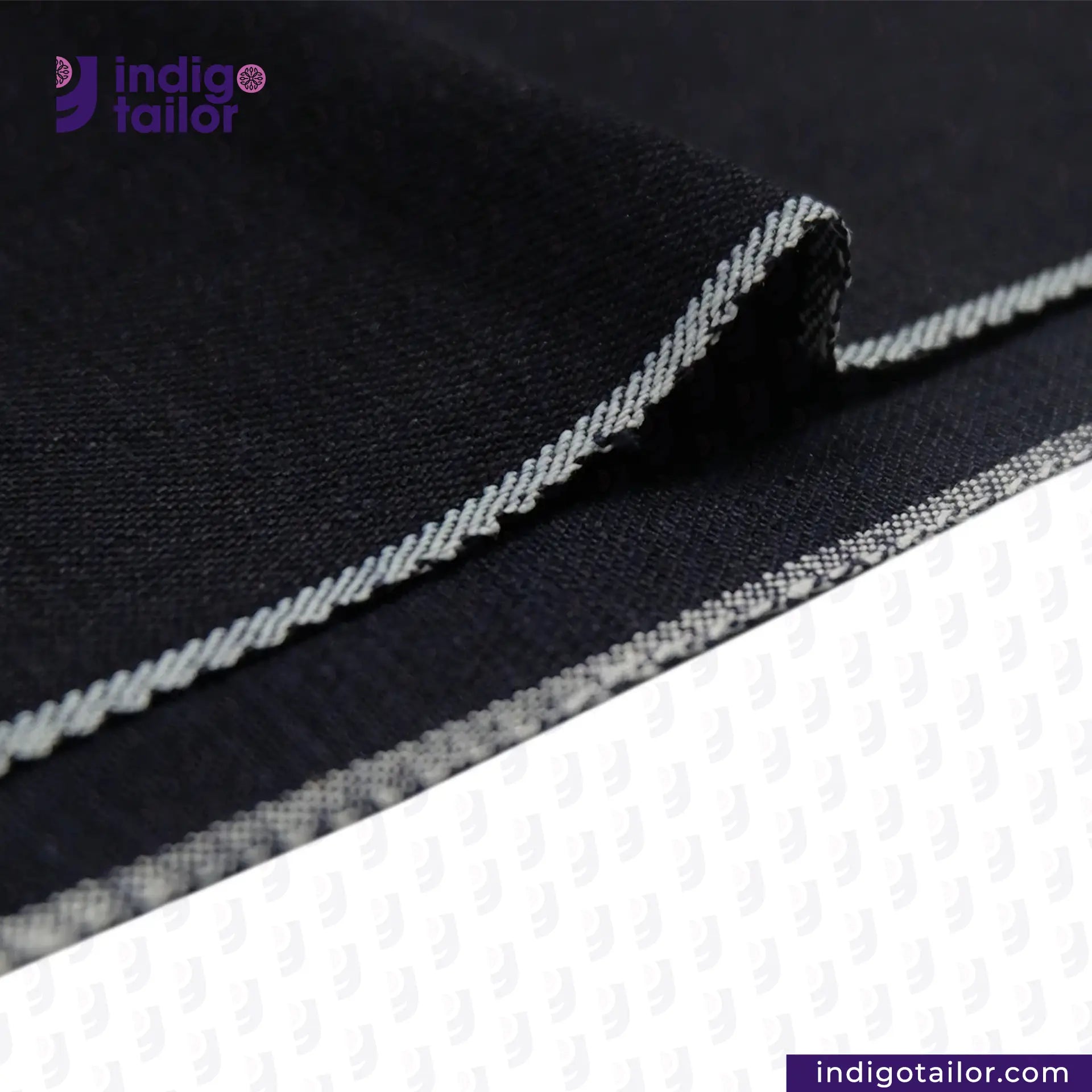 Close-up of INDIGO x INDIGO SUMMER TWILL SELVEDGE DENIM fabric with white stitching, featuring the Indigotailor logo.