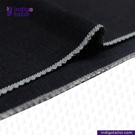 Close-up of INDIGO x INDIGO SUMMER TWILL SELVEDGE DENIM fabric with white stitching, featuring the Indigotailor logo.