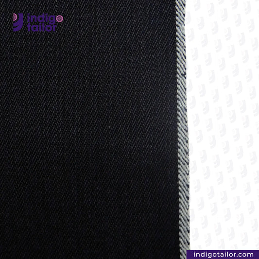 Close-up of INDIGO x INDIGO SUMMER TWILL SELVEDGE DENIM fabric with 'Indigotailor' logo and website URL.