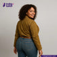 Woman wearing a KHAKI HERRINGBONE COVERALL JACKET jacket and blue jeans with 'Indigo Tailor' logo and website on a gray background