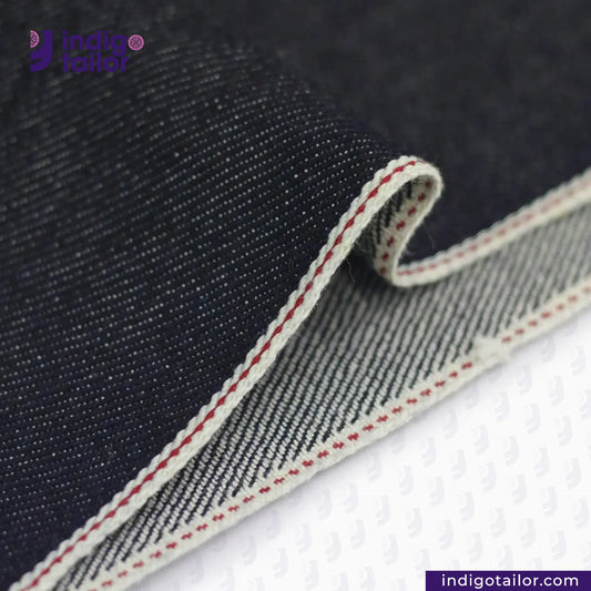 Close-up of KUROKI CLASSIC RED LINE SELVEDGE fabric with a visible brand logo and website.