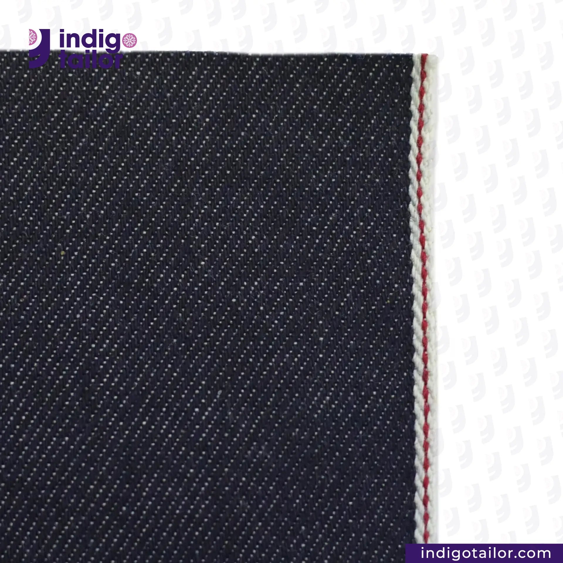 Close-up of KUROKI CLASSIC RED LINE SELVEDGE fabric with a visible seam on a white background, featuring the Indigo Tailor logo.