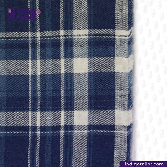Close-up of MADRAS SPRING BLUE  WHITE CHECK fabric with 'Indigo Tailor' branding.