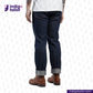 Person wearing MEDIUM BLUE DENIM LIVIDUS SELVEDGE jeans and brown boots on a white background with 'Indigo Tailor' branding.