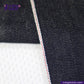 Close-up of METALLIC GOLD WEFT SELVEDGE DENIM fabric with a visible brand logo and website text.