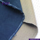 Close-up of NATURAL INDIGO DYED SUEDE fabric with 'indigotailor' branding.