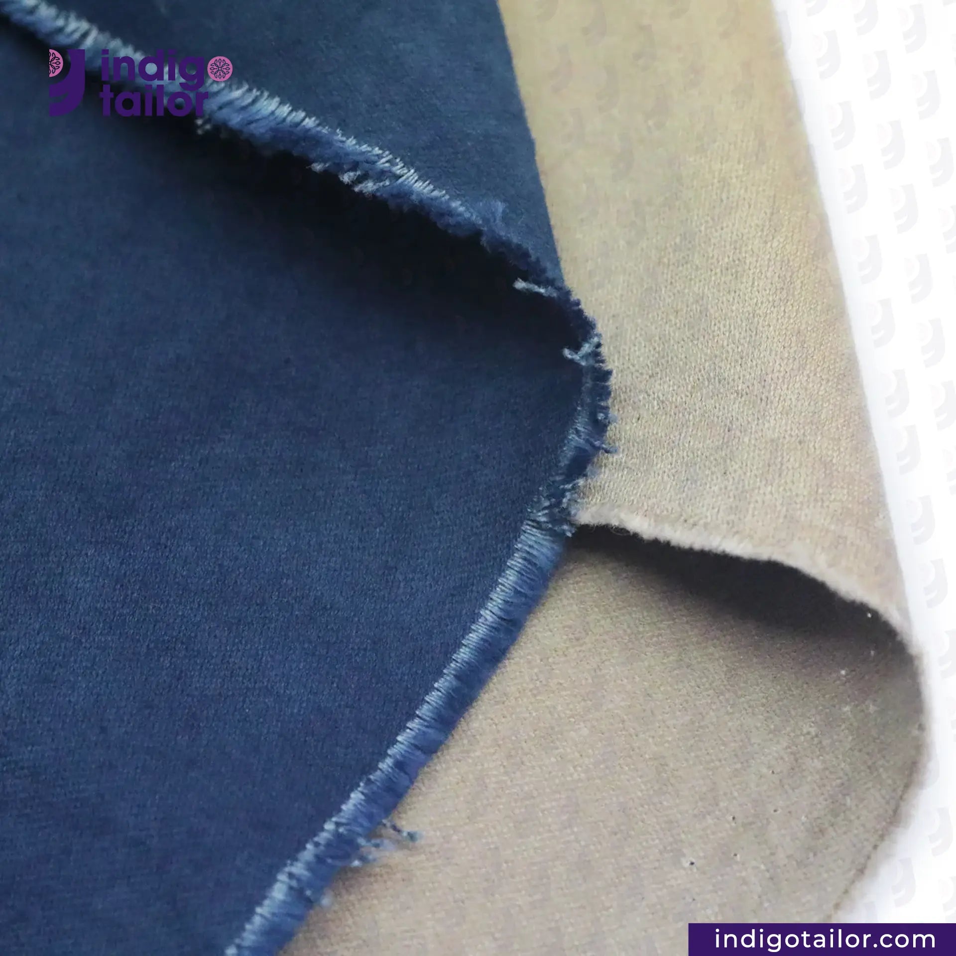 Close-up of NATURAL INDIGO DYED SUEDE fabric with 'Indigo Tailor' branding.