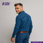 Man wearing a NATURAL INDIGO SUEDE SHACKET shirt and jeans with 'Indigo Tailor' logo.