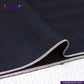 Close-up of NDL200 INDIGO x INDIGO HERRINGBONE DENIM fabric with a striped edge on a white background, featuring the Indigo Tailor logo.