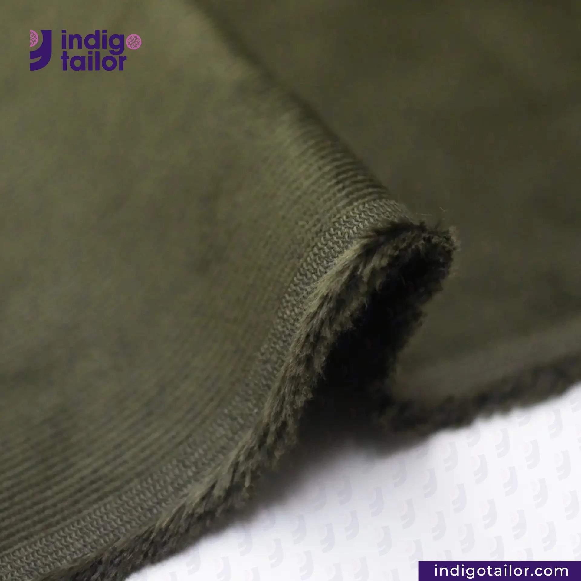Close-up of OLIVE CORDUROY fabric with 'Indigo Tailor' branding.