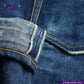 Close-up of blue denim fabric with stitching detail, featuring the Indigotailor logo.