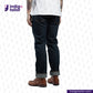 Person wearing dark blue jeans and brown boots with 'Indigo Tailor' logo and website URL on a white background.
