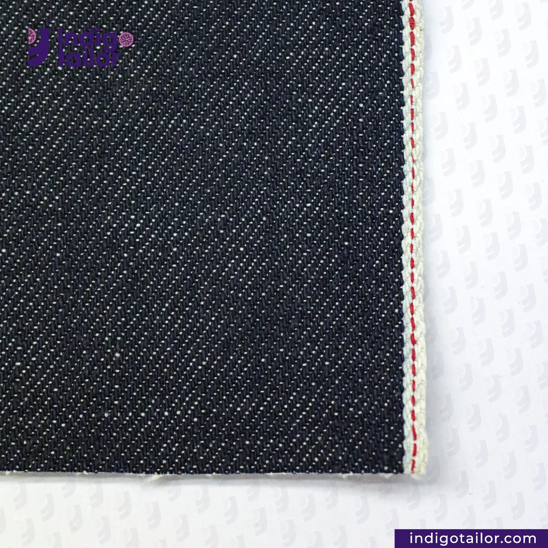 Close-up of ORGANIC NATURAL COTTON SELVEDGE DENIM fabric with a visible brand logo on a white background
