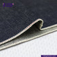 Close-up of ORGANIC NATURAL COTTON SELVEDGE DENIM fabric with visible stitching, featuring the Indigo Tailor logo.