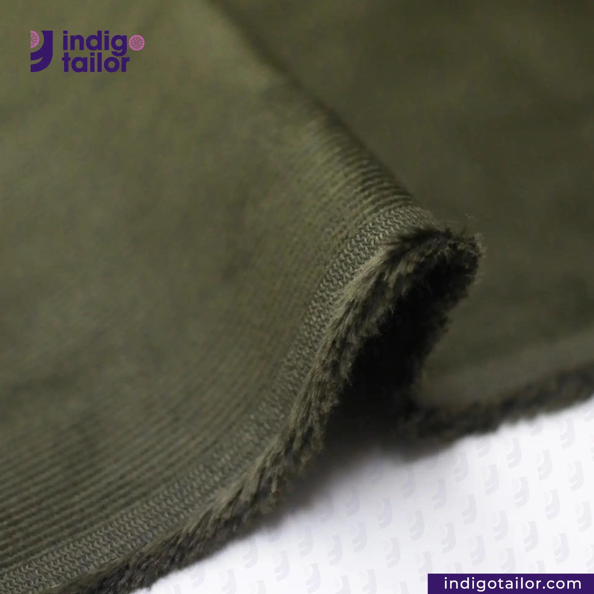 Close-up of Olive Green Corduroy fabric with 'Indigotailor' logo and website on a white background