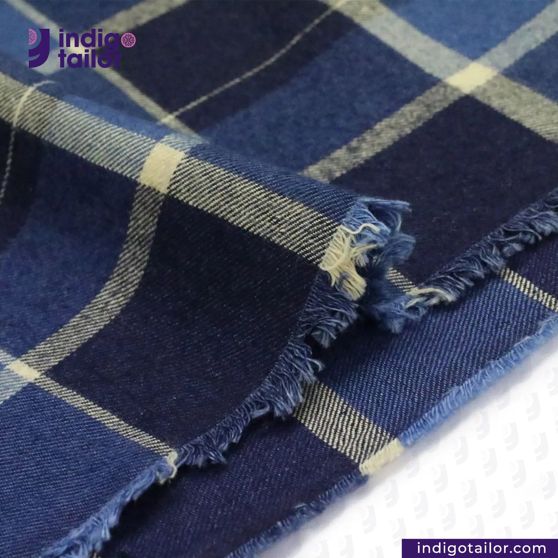 PLAID FLANNEL DEEP INDIGO NAVY/BEIGE fabric with frayed edges on a white background, featuring the Indigotailor logo.