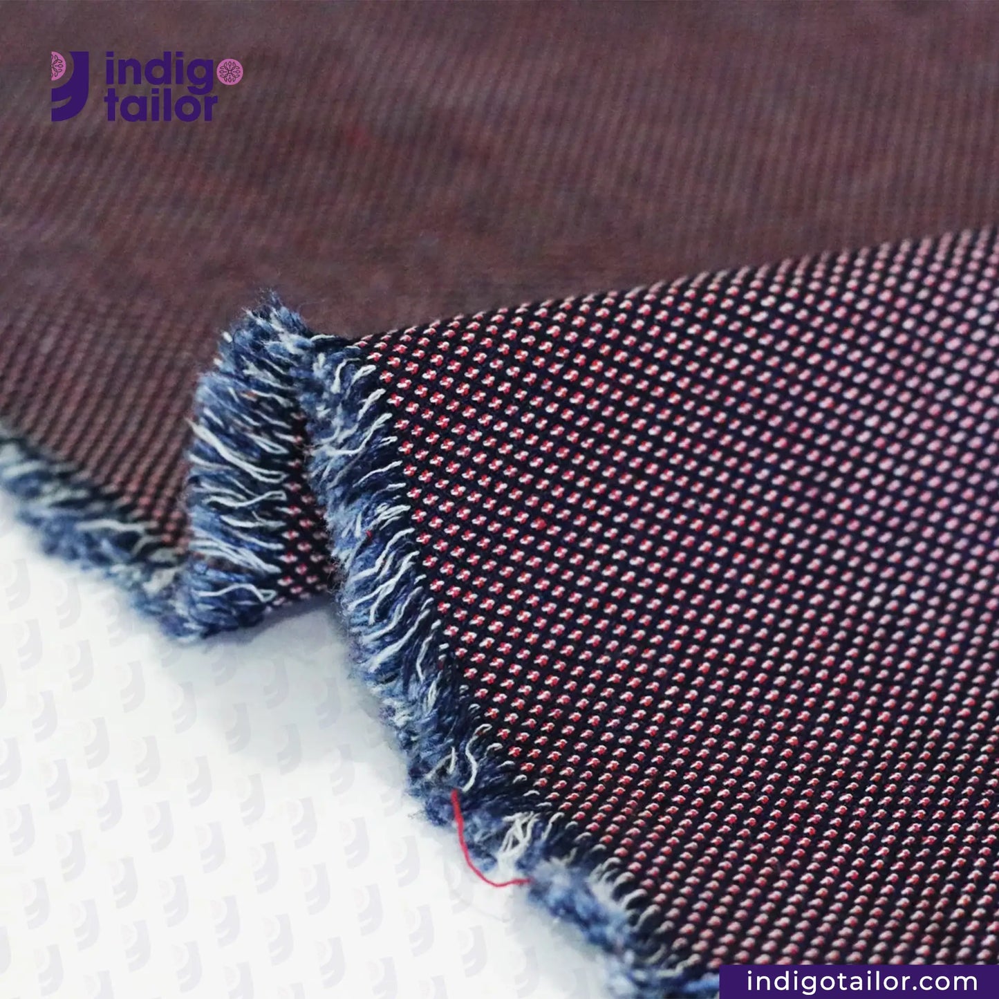 Close-up of RED SASHIKO fabric with 'indigo tailor' branding.