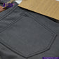 Close-up of a SMOKE GREY DENIM jeans pocket with 'Indigotailor' branding in the corner.
