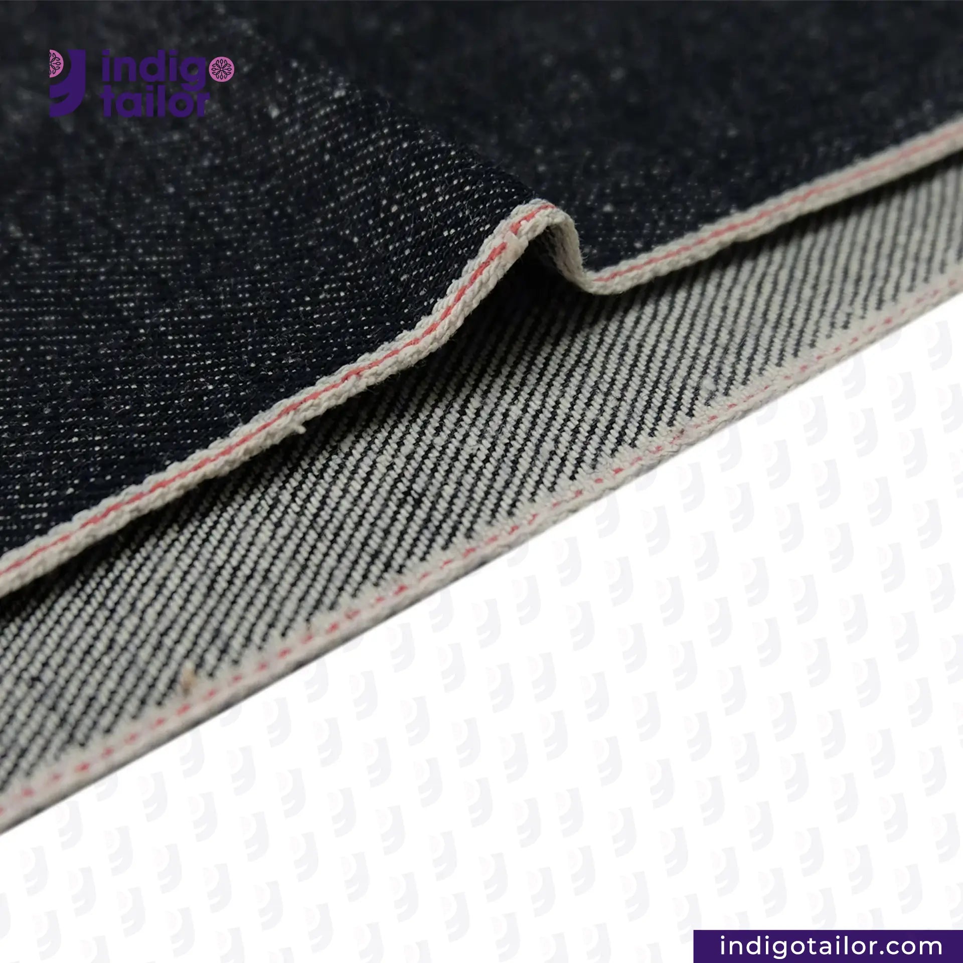 Close-up of SNOWY SELVEDGE DENIM fabric with 'Indigo Tailor' branding on a white background