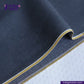 Close-up of SPACE GREY DENIM fabric with yellow stitching, featuring Indigotailor logo.