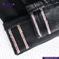 Close-up of SUPER BLACK DENIM jeans with white and red stitching on a white background, featuring the Indigotailor logo.