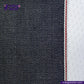 Close-up of SUPER SOFT FLUFFY SELVEDGE DENIM fabric with a white stripe and red stitching, featuring the Indigo Tailor logo.