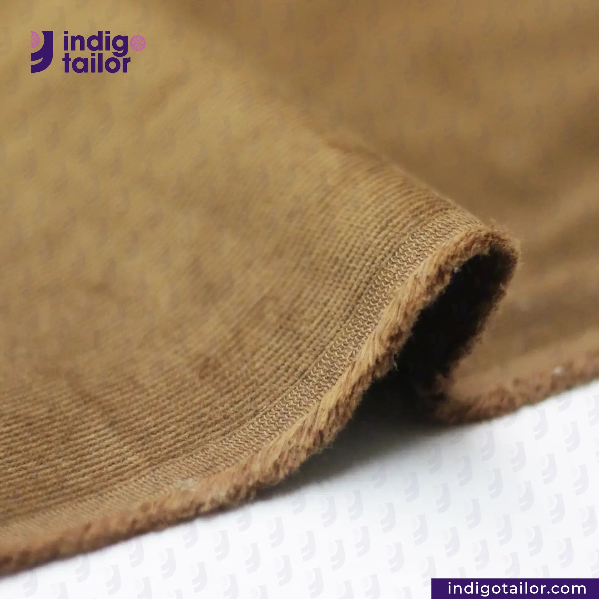 Close-up of brown fabric with 'indigotailor' logo in the corner. TANNED CORDUROY