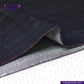 Close-up of TROPIC -CITY- DENIM fabric with visible stitching, branded 'Indigo Tailor'.