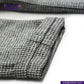 Close-up of TWEED HOUNDSTOOTH COVERALL JACKET pattern fabric with 'indigotailor' branding.