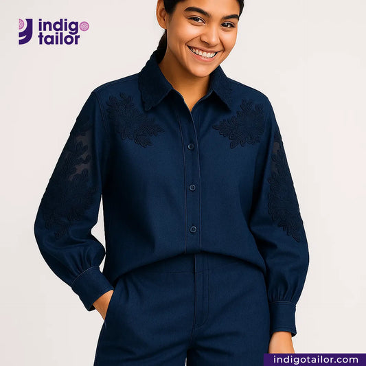 Woman wearing a TWO TONE SELVEDGE PAPER WEIGHT DENIM embroidered shirt and pants with 'Indigo Tailor' logo.