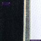 Close-up of TWO TONE SELVEDGE PAPER WEIGHT DENIM denim fabric with visible stitching, featuring 'Indigo Tailor' logo.