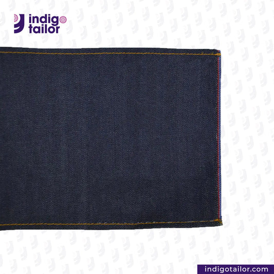 Close-up of TWO TONE STRETCH SELVEDGE DENIM fabric with 'Indigo Tailor' logo and website URL.