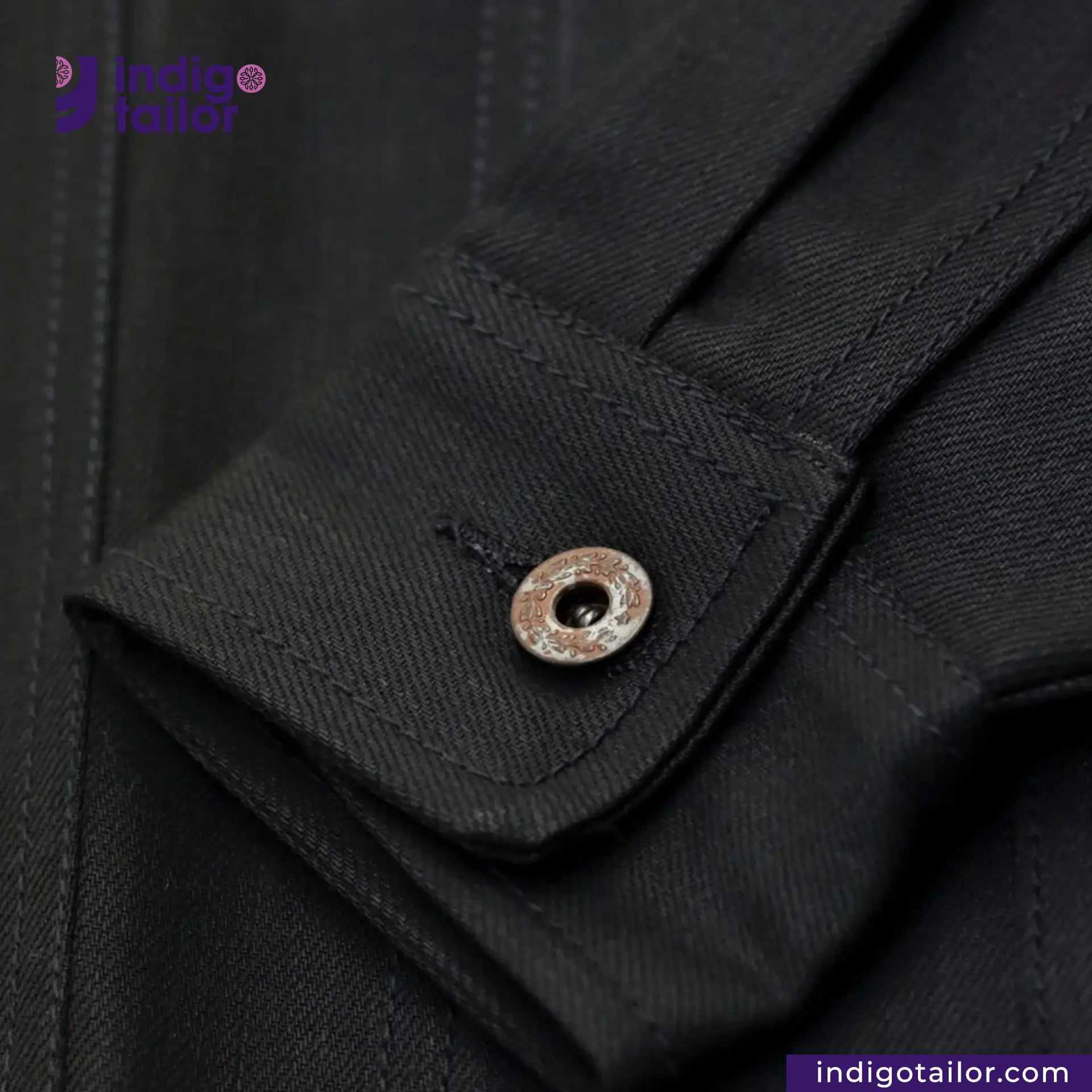 Close-up of a TYPE III DOUBLE BLACK TRUCKER JACKET with a button, featuring the brand 'Indigotailor'.