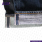 Close-up of VINTAGE SLUB DENIM jeans with a brand logo in the corner