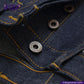 Close-up of VINTAGE SLUB DENIM jeans with metal buttons and yellow stitching, featuring Indigo Tailor logo.
