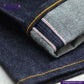 Close-up of VINTAGE SLUB DENIM jeans with a brand logo in the corner.