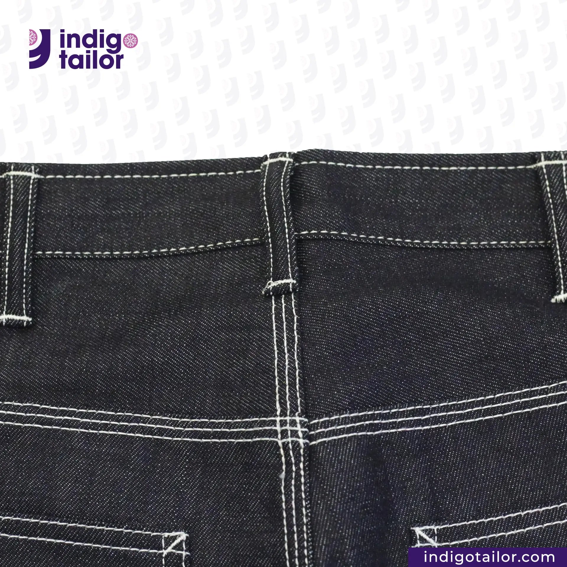 Close-up of Vintage Workwear Jeans  with white stitching on a white background, featuring the Indigotailor logo.