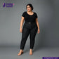 Woman wearing WASHED BLACK x BLACK SELVEDGE DENIM jeans and a black top on a gray background with 'Indigotailor' branding.