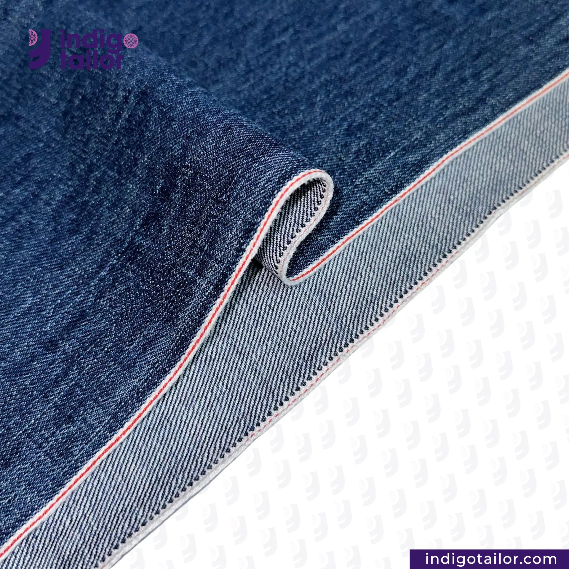 Close-up of WASHED VINTAGE SLUB SELVEDGE DENIM fabric with a visible brand logo on a white background