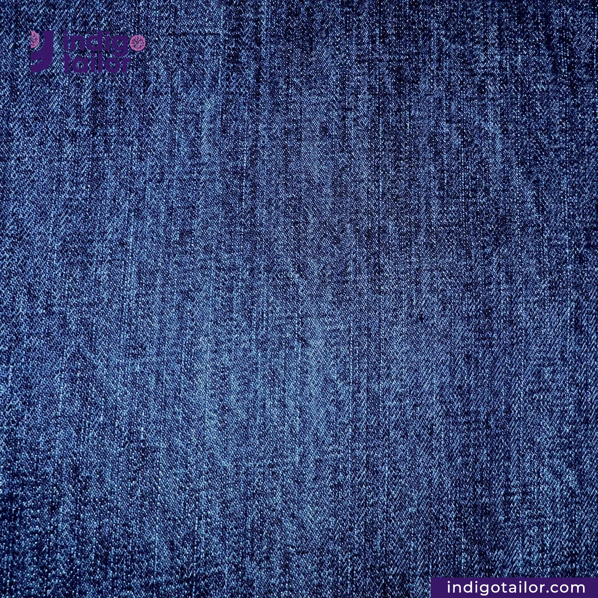 Close-up of WASHED VINTAGE SLUB SELVEDGE DENIM fabric with 'Indigo Tailor' branding.