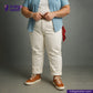 Person wearing a blue shirt, WHITE DENIM DOTTED RED SELVEDGE pants, and brown shoes on a gray background with 'Indigotailor' branding.