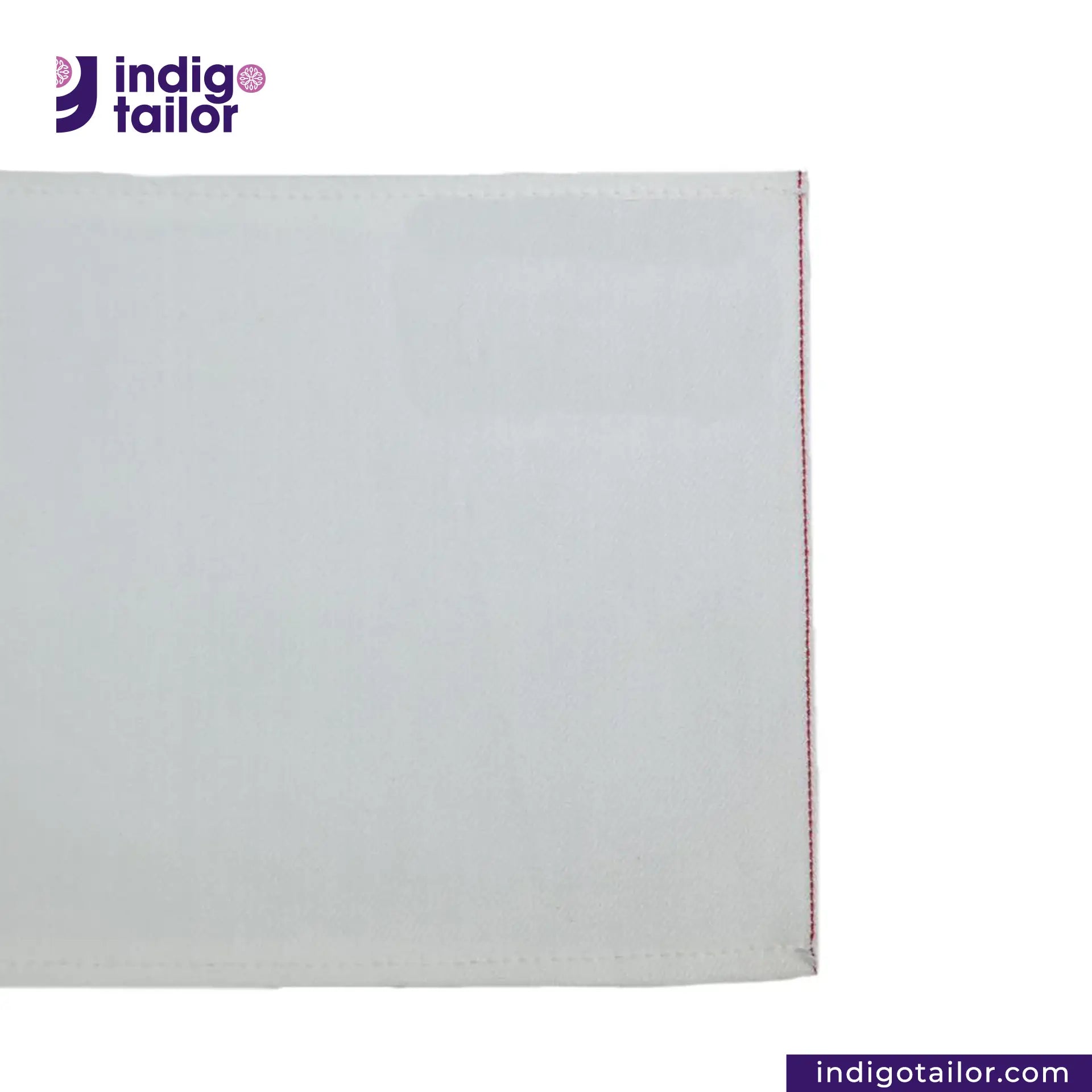 WHITE DENIM DOTTED RED SELVEDGE fabric swatch with a visible brand logo on a white background